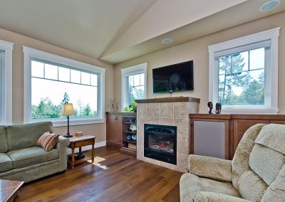 Nanoose Custom Home: Built Green Gold: Fireplace with built in cabinets