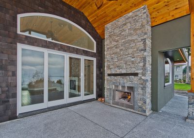 Saltair Custom Home with Detached Carriage house: Wood burning outdoor fireplace