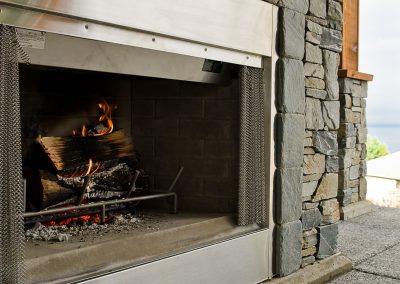 Saltair Custom Home with Detached Carriage house: Majestic outdoor wood fireplace