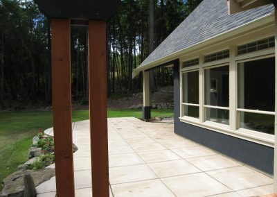 Yellowpoint Custom Home: Coloured concrete broom finish patio