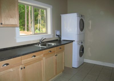 Yellowpoint Custom Home: Large Laundry room with stacker